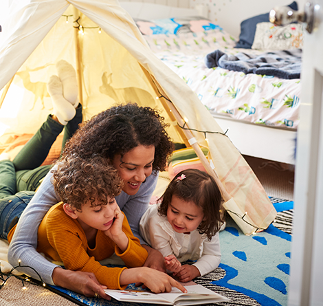mom reading with kids in tent
