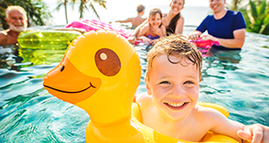 Boy in pool on yellow ducky float