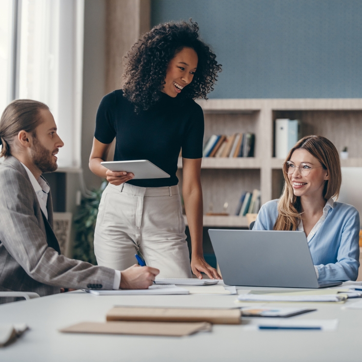 Coworkers in an office working together and talking.