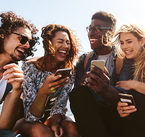 A group of friends hanging out with their cell phones