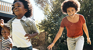 Woman playing with kids in yard